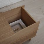 Mit nur wenigen Handgriffen lässt sich der Deckel der Sitzbank CORRELATION von We Do Wood zur Seite schieben, um Textilien, Bücher oder andere Gegenstände zu verstauen moderne Sitzbank mit Aufbewahrung aus Eichenholz - CORRELATION von We Do Wood