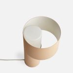 Das große Rohr der eleganten Tischleuchte TANGENT TABLE LAMP von WOUD dient als Lampenschirm Elegante Tischleuchte aus Metall und Opalglas - Die Tangent Table Lamp von Woud